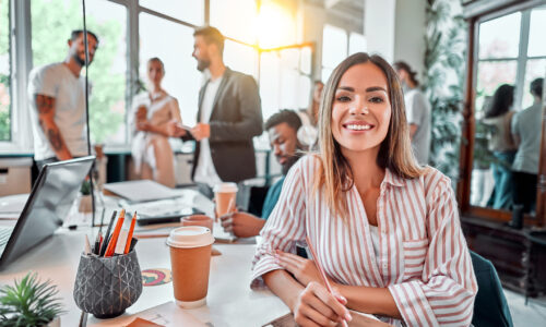 Smiling female employee in coworking space